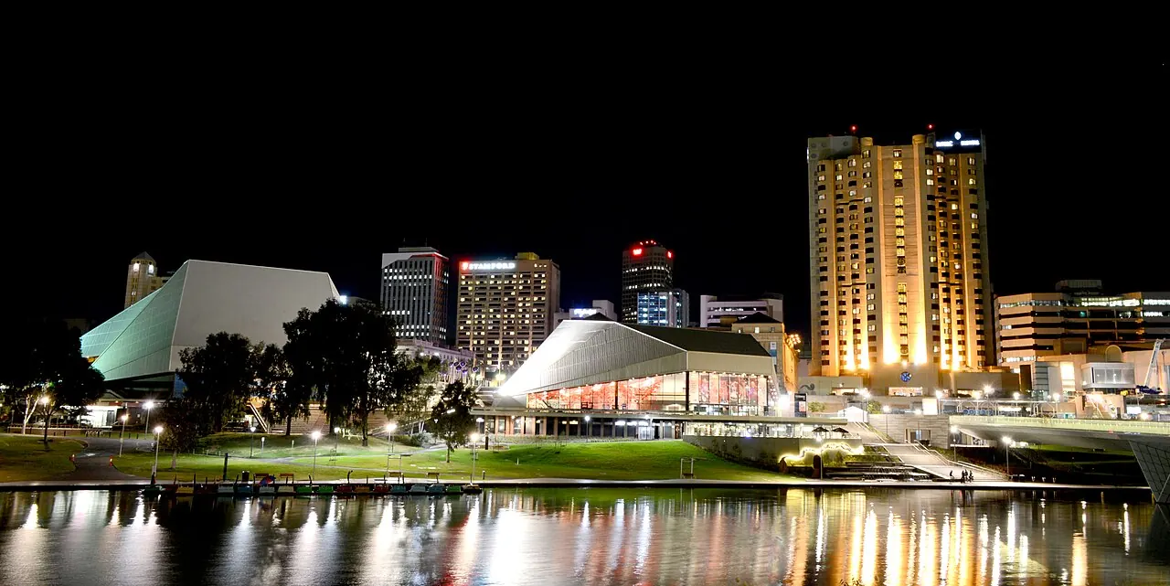 The Festival Centre and city lit at night across the river