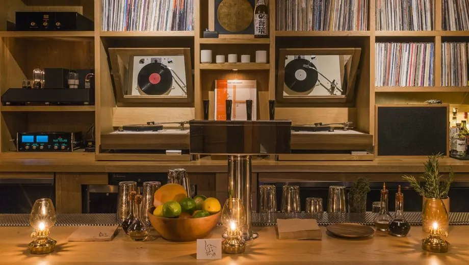 Shelves of records and audio equipment behind a bar