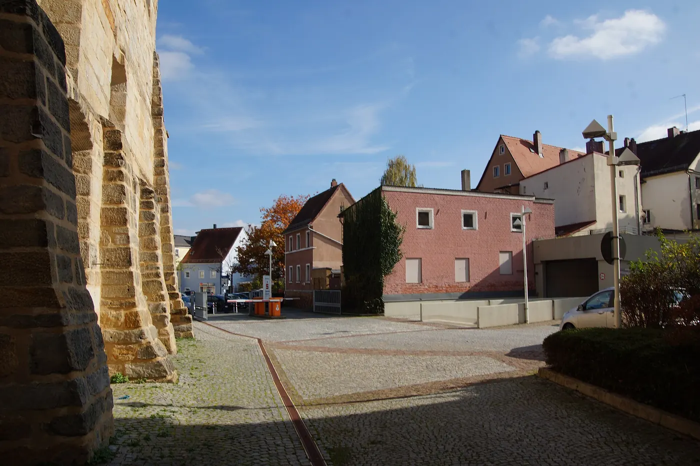 A stone wall and a quiet street beside the opera house
