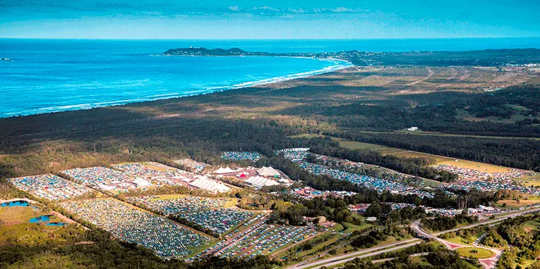 An aerial view of the coast and festival fields at Byron Bay