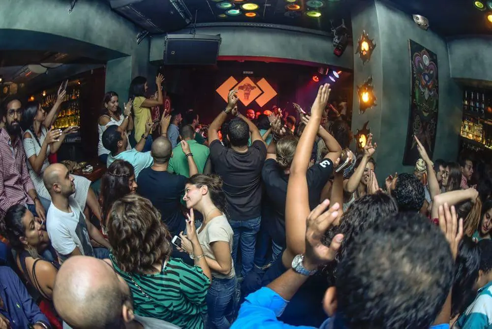 A crowd cheering inside a club