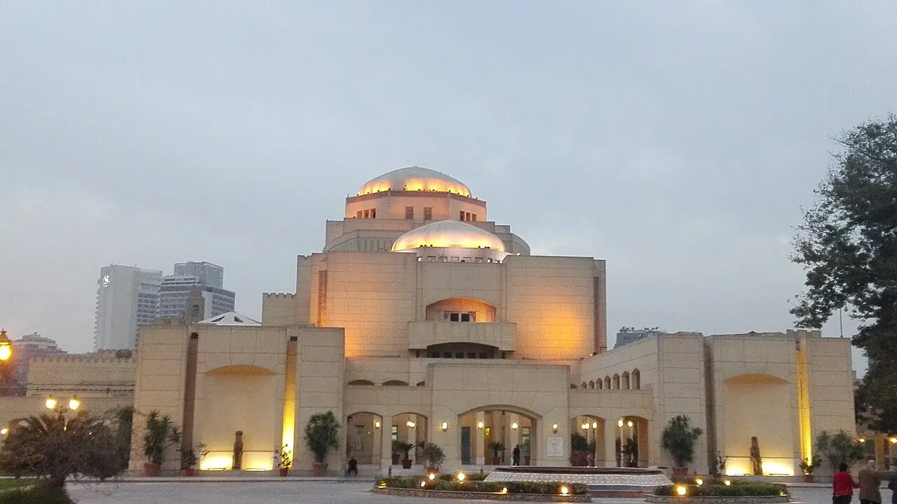 The domed opera house building with warm lighting at dusk