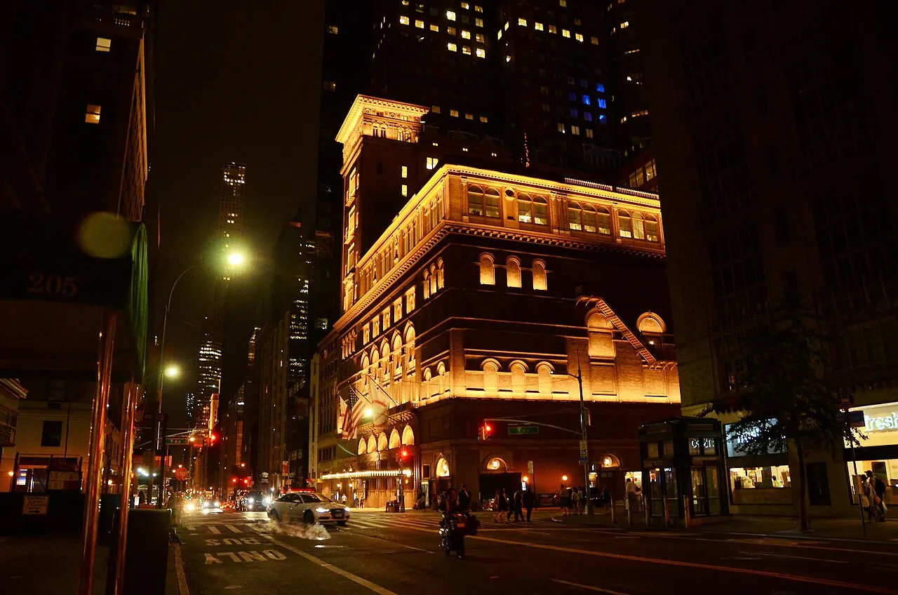 Carnegie Hall's lit marquee at night on the street