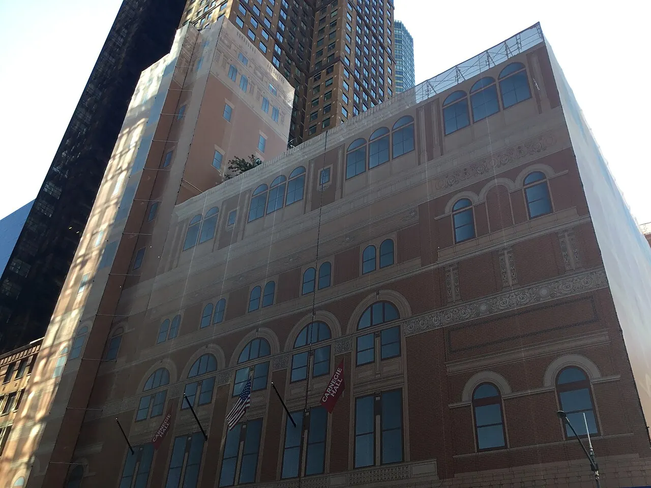 The brick and terracotta side of Carnegie Hall seen from below