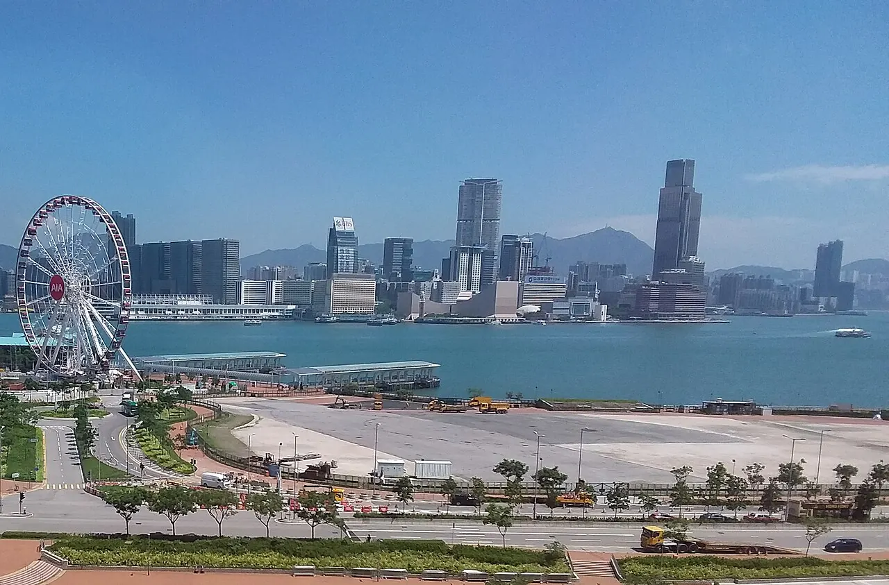 A waterfront festival site with the harbour and a ferris wheel
