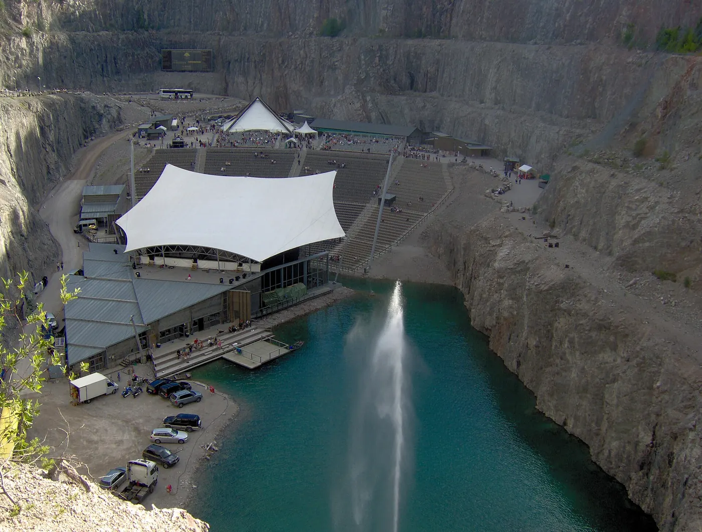 The quarry lake with a white tent roof above the seating