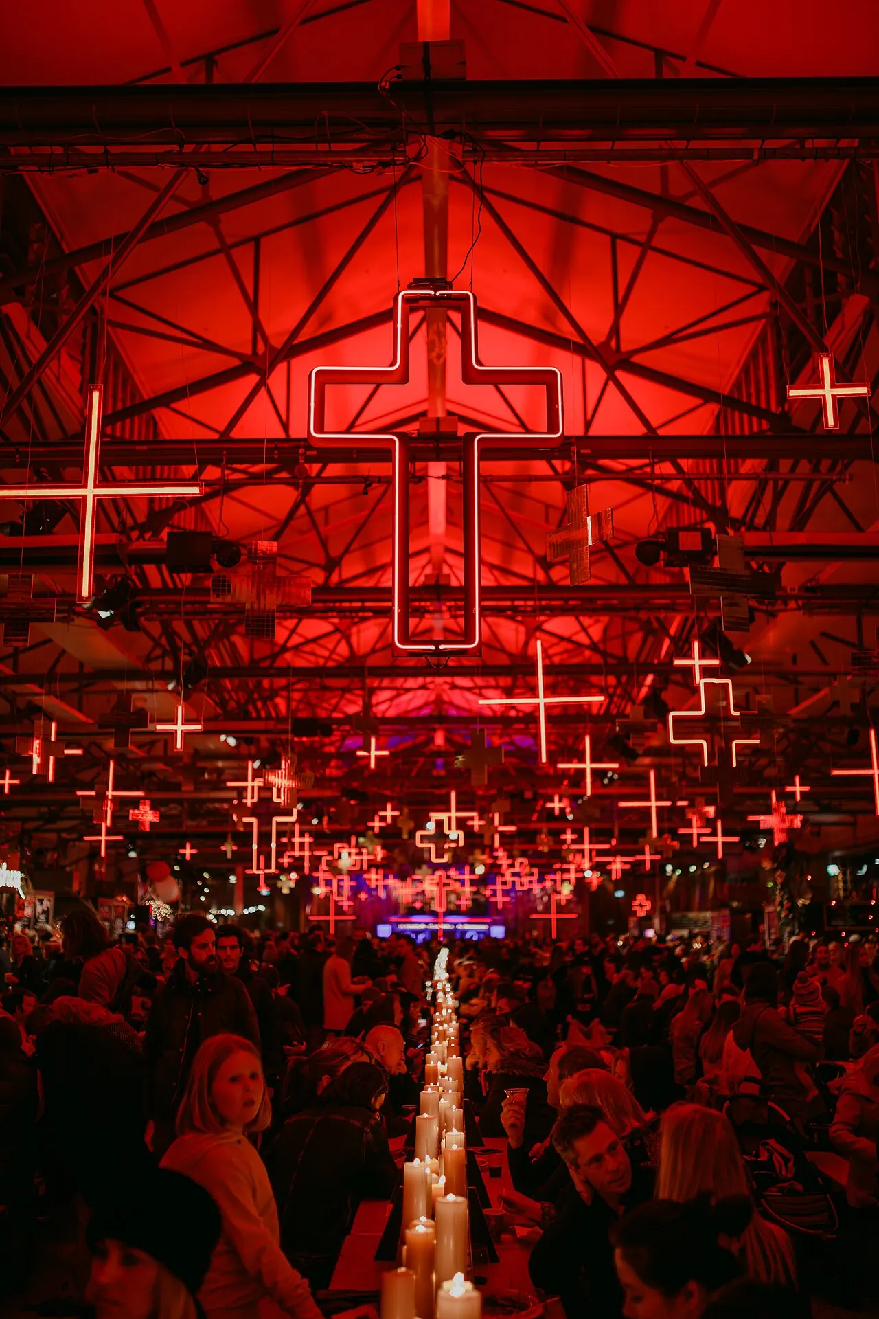 A red-lit warehouse with a glowing lattice