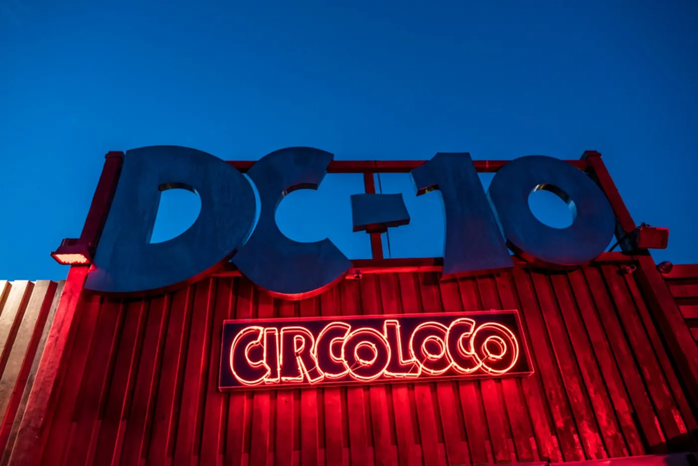 The blue DC-10 sign above a red Circoloco banner