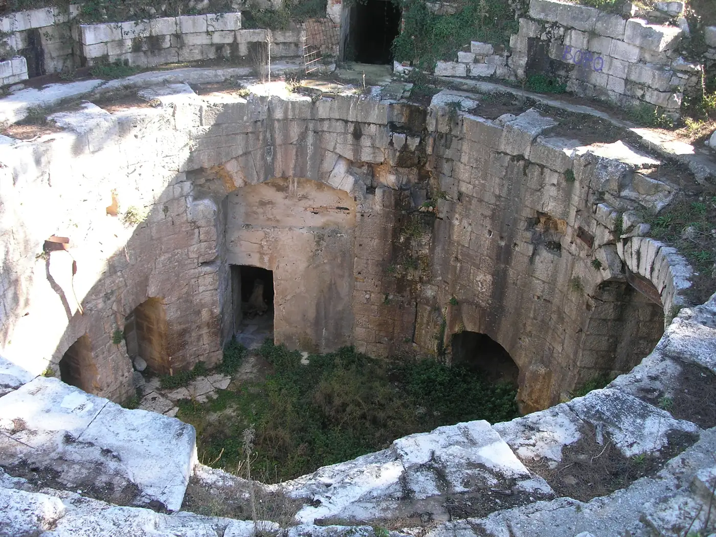 A ruined stone pit and arches at Fort Punta Christo near Pula, the festival's home until 2019