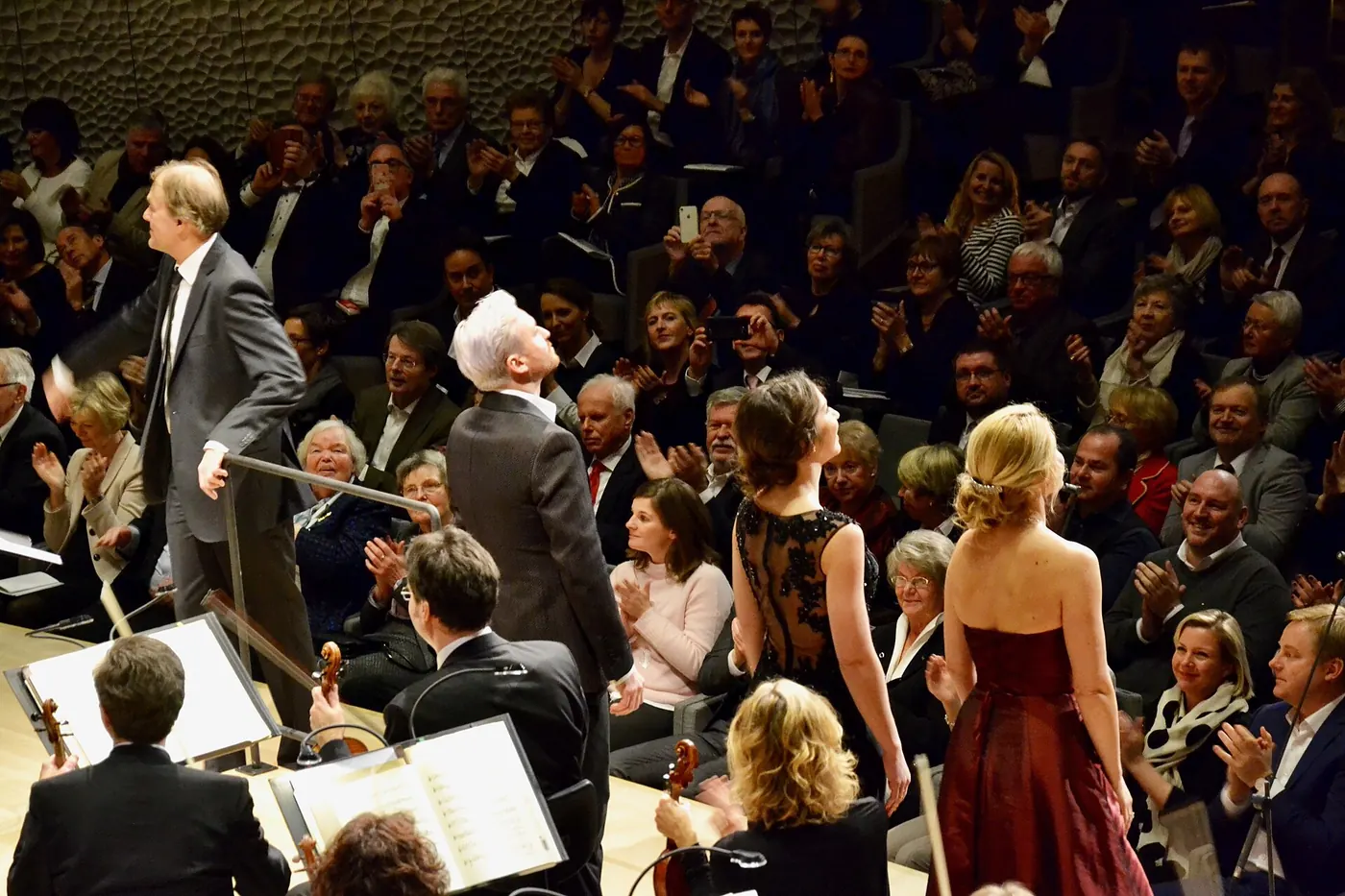 Orchestra players and audience in the hall
