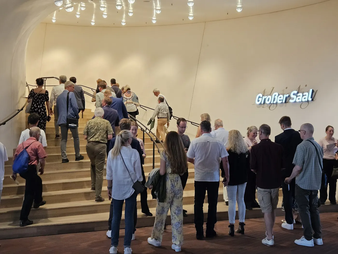 Visitors on a broad staircase inside the Elbphilharmonie