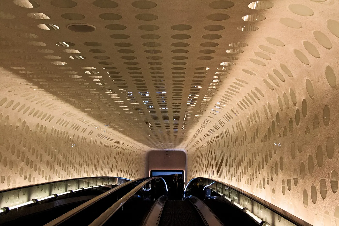 The long curved escalator tunnel