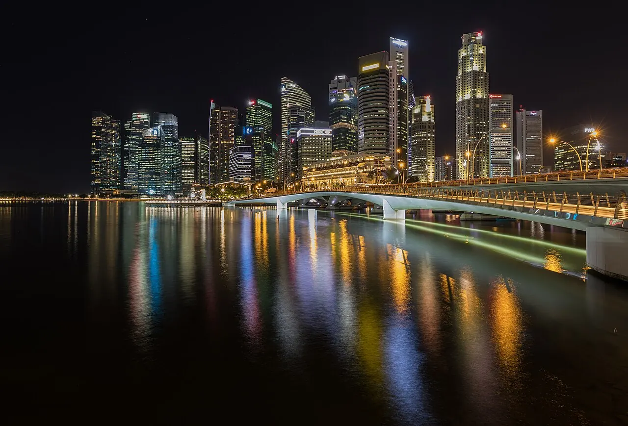 The Singapore skyline reflected in the bay at night