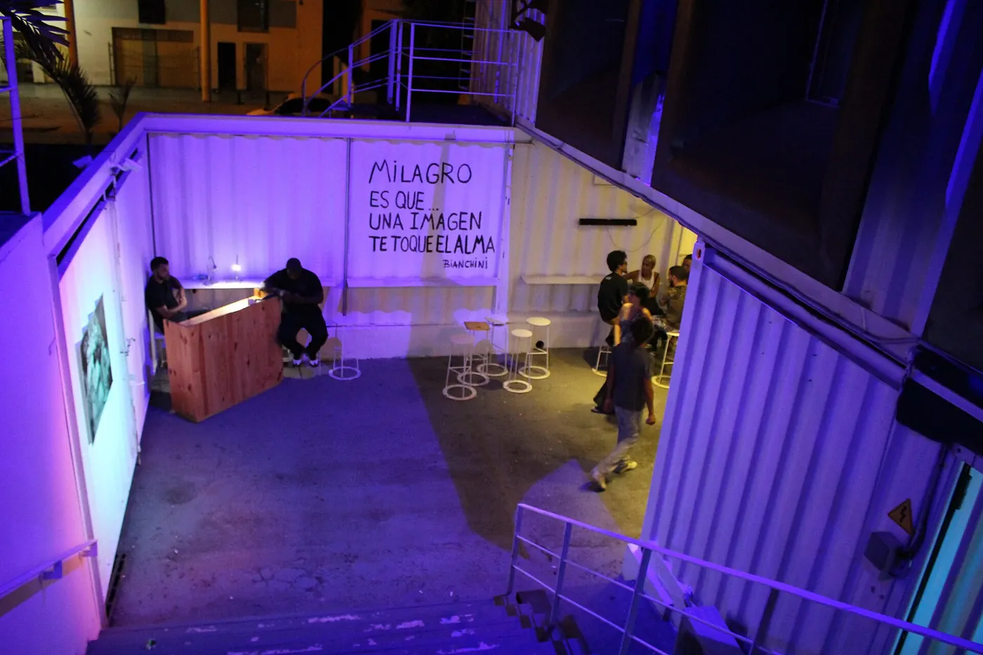 A purple-lit room with a display and a counter at Fábrica de Arte Cubano