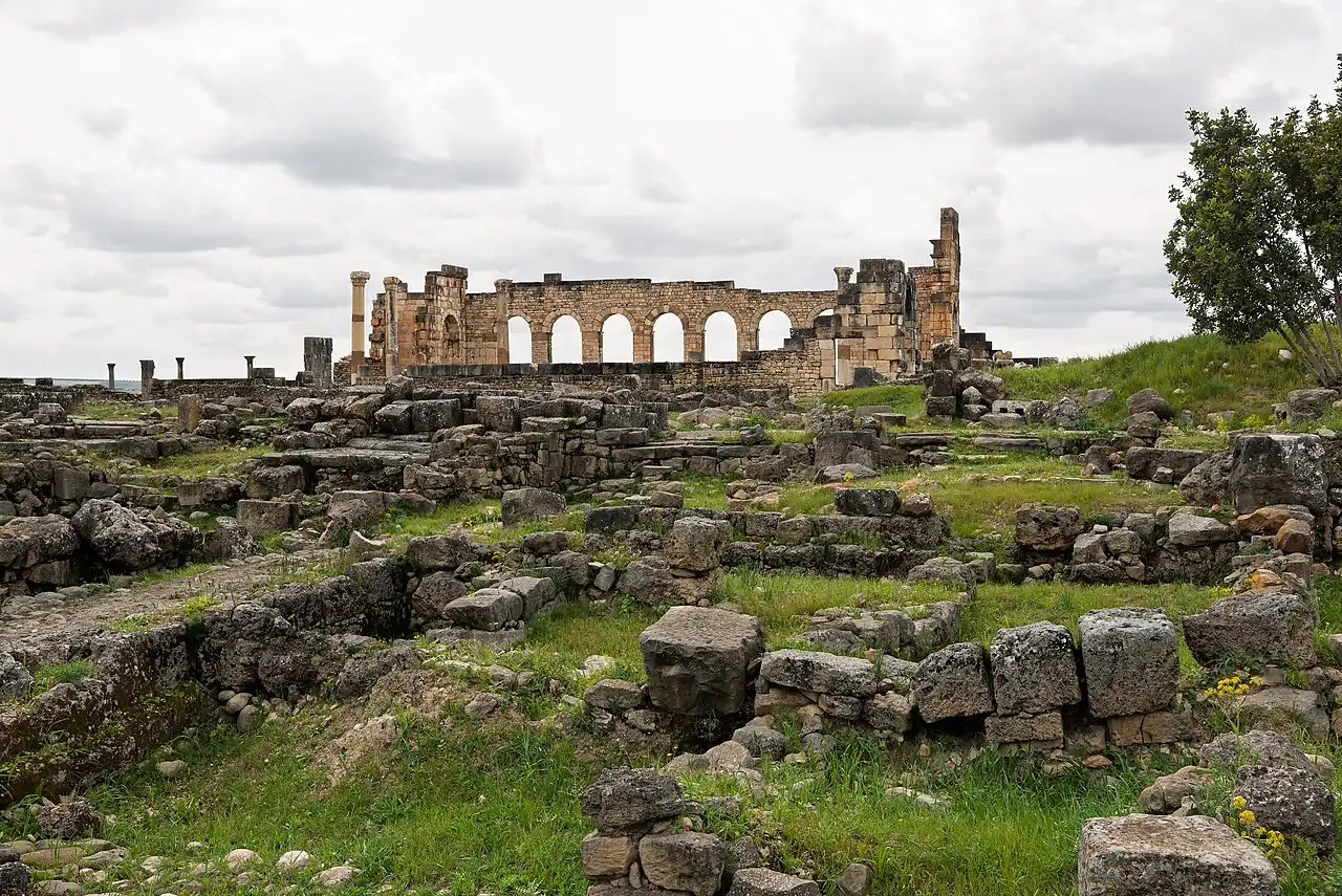 Ancient stone ruins on a green hillside
