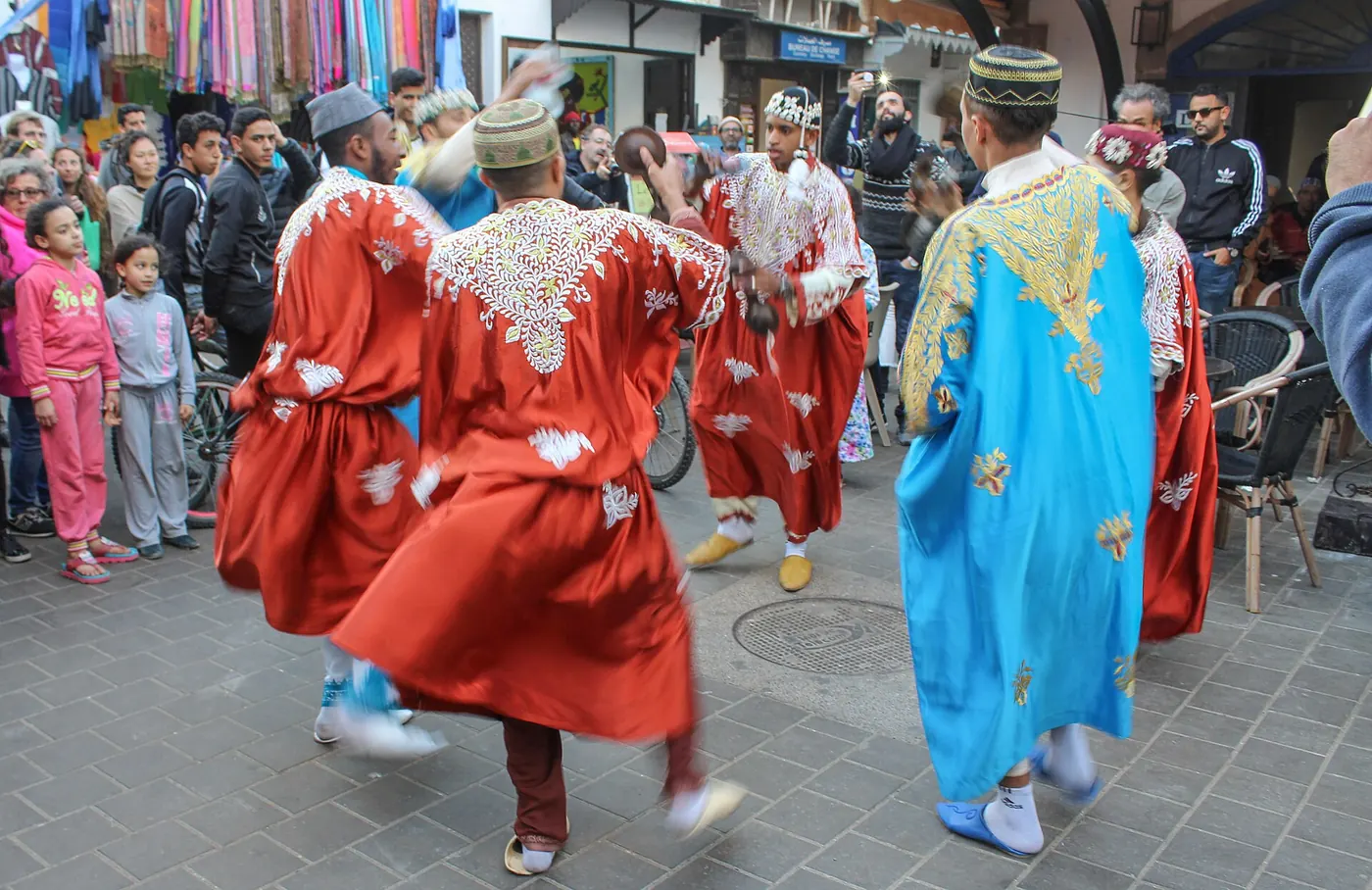 Dancers in red and blue robes in the street