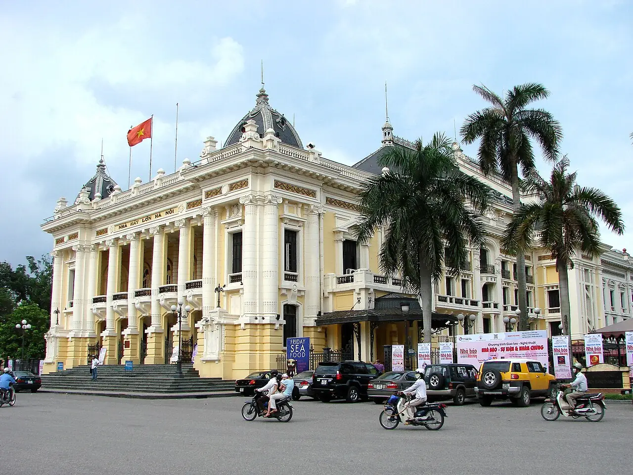 The Opera House facade from across the street with a red flag
