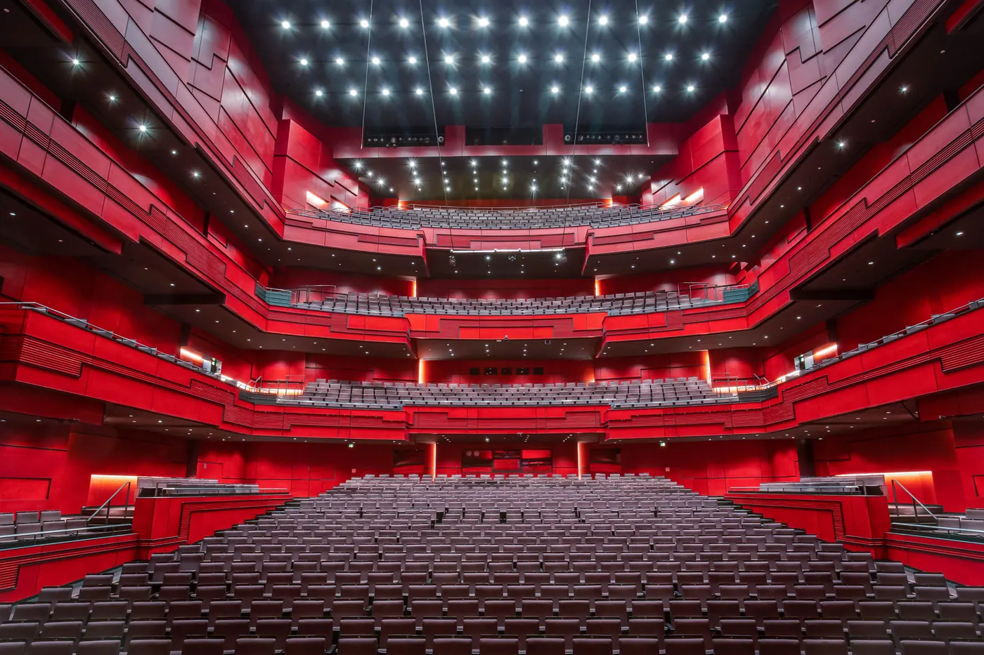 Rows of seats in Eldborg with the red tiered balconies rising behind