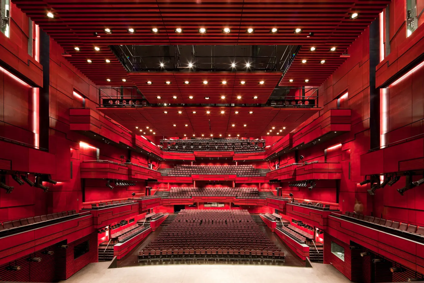 Harpa's Eldborg hall, its balconies lit in red