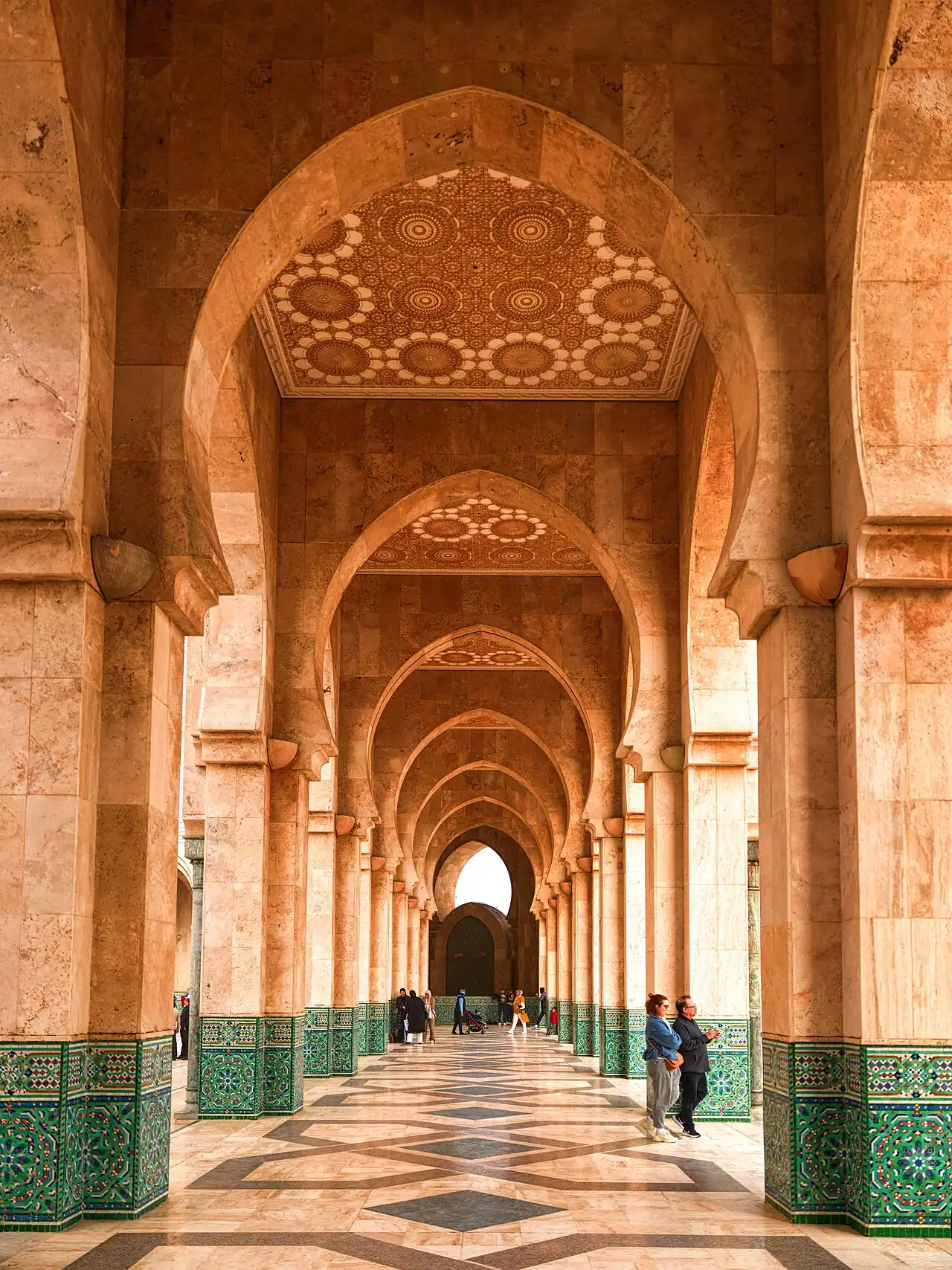 A tiled horseshoe-arched corridor in the mosque