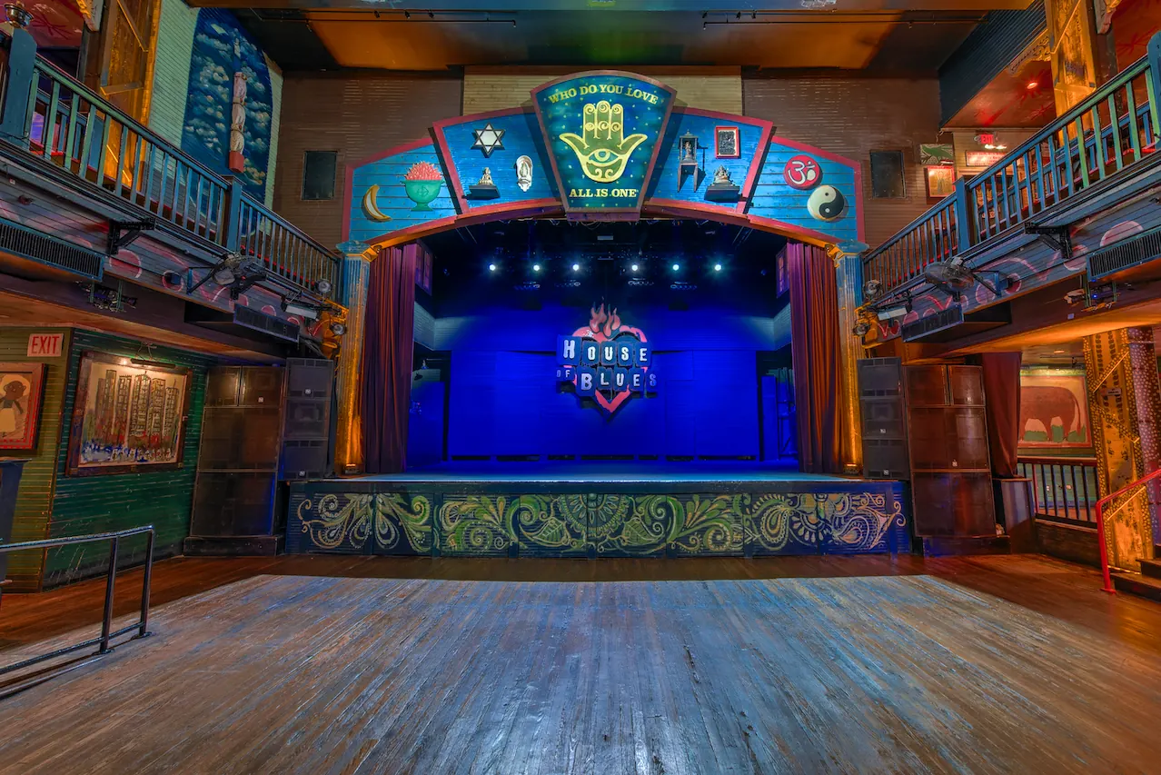 The stage with blue lighting from the back of the hall