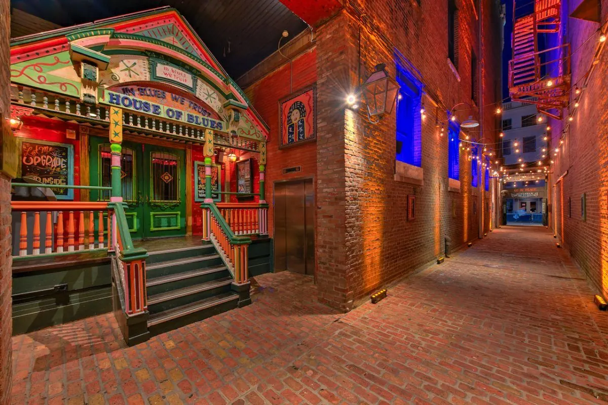 A narrow brick alley with folk-art decoration beside the venue