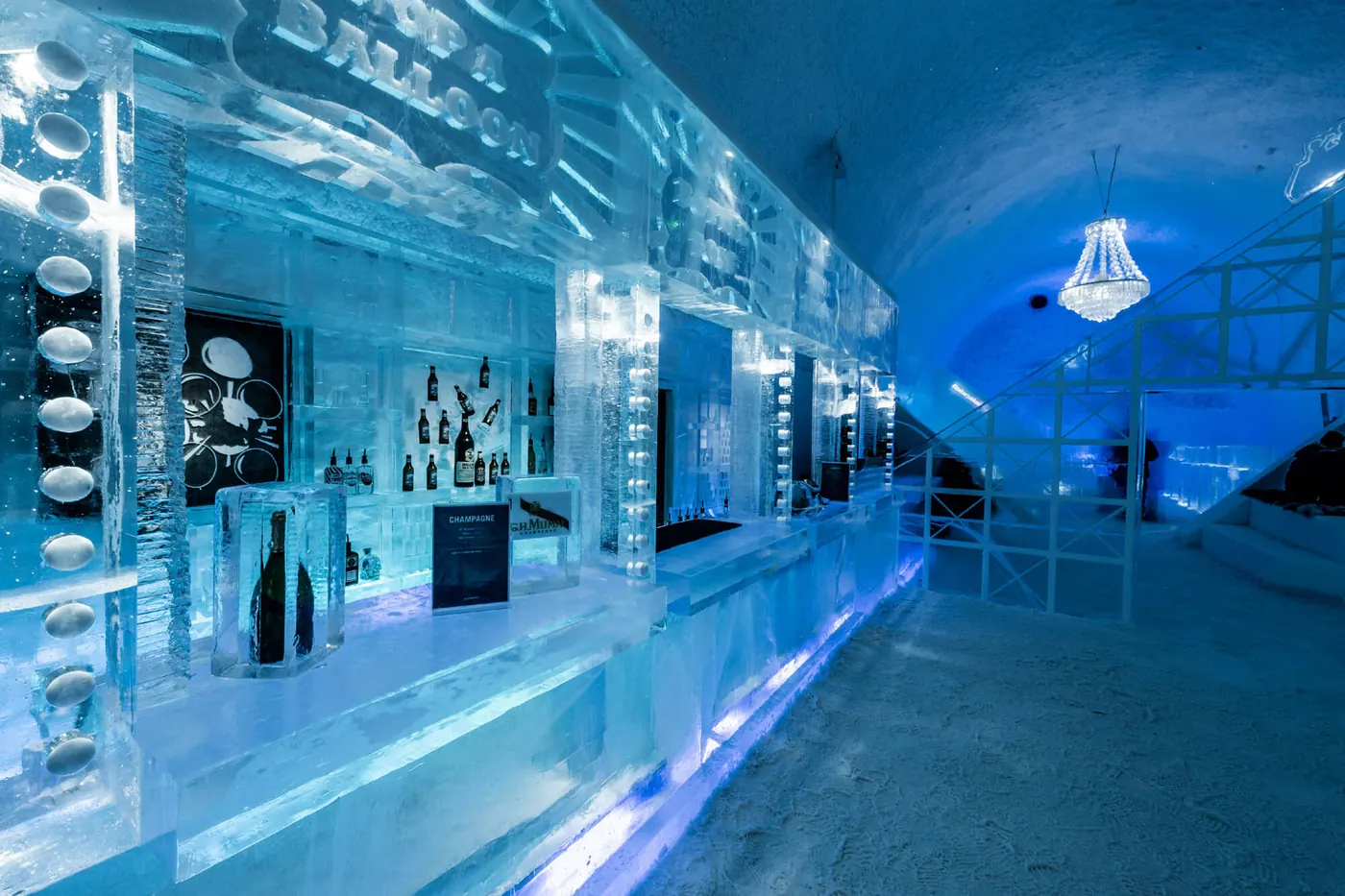 A blue-lit ice bar with carved shelves