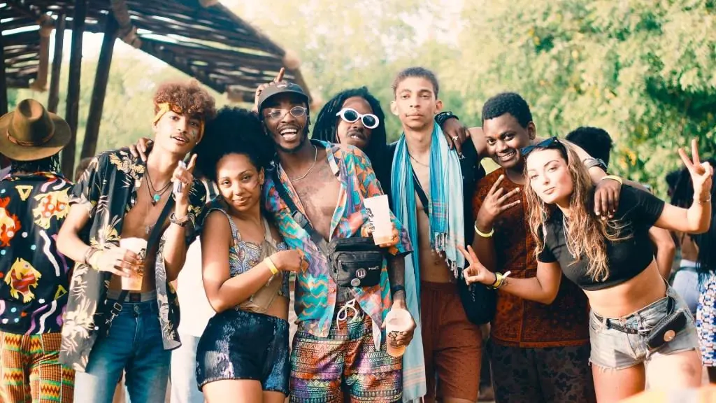 A group of friends laughing and posing together outdoors