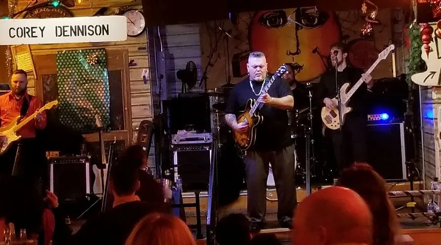 A band playing beneath a Corey Dennison banner at Kingston Mines