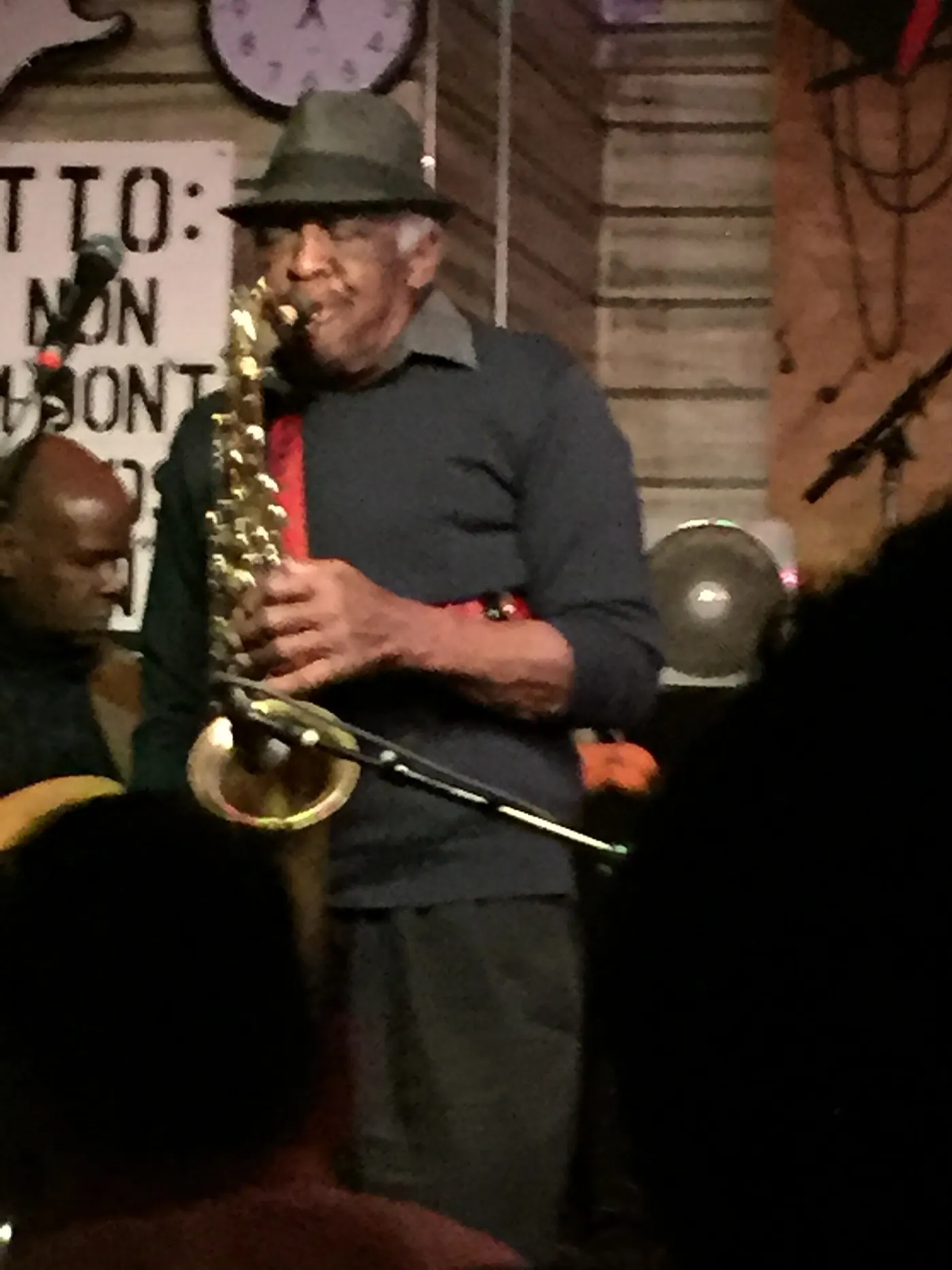 A saxophonist playing in the dark