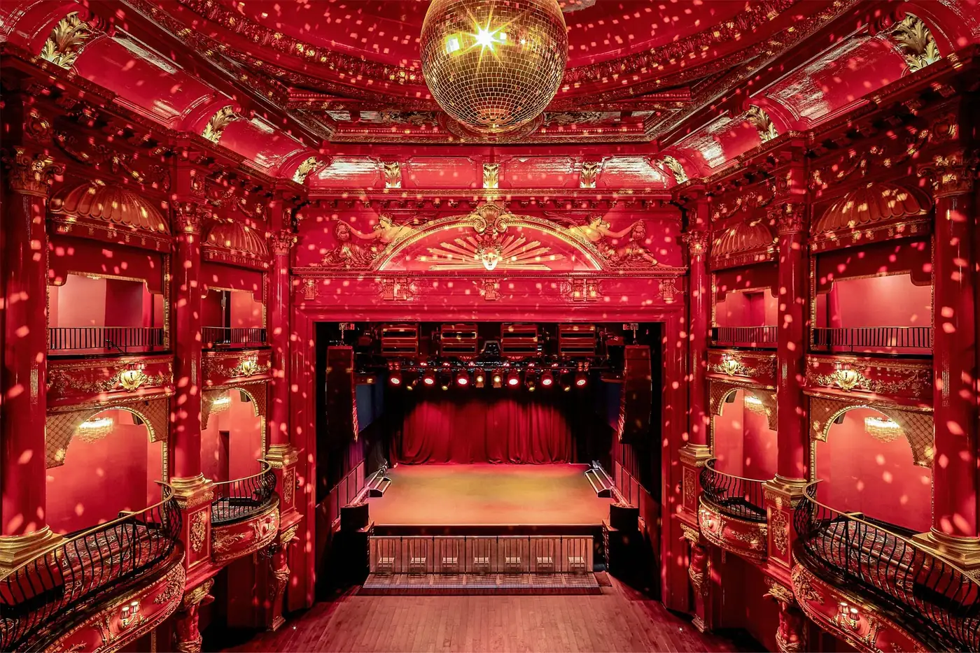 The red and gold auditorium at KOKO, with stage, balconies and a domed ceiling