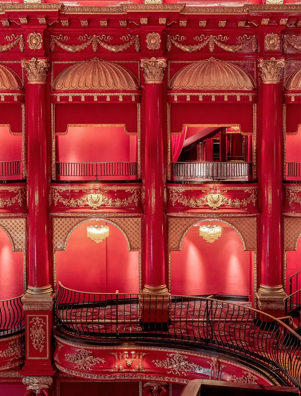 A row of gilded red balcony boxes at KOKO
