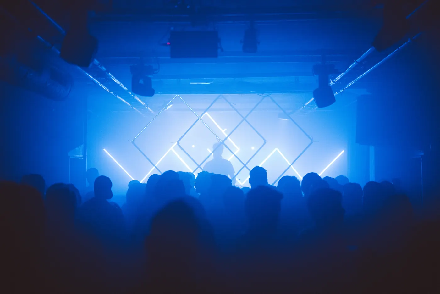 Blue stage light over a crowd