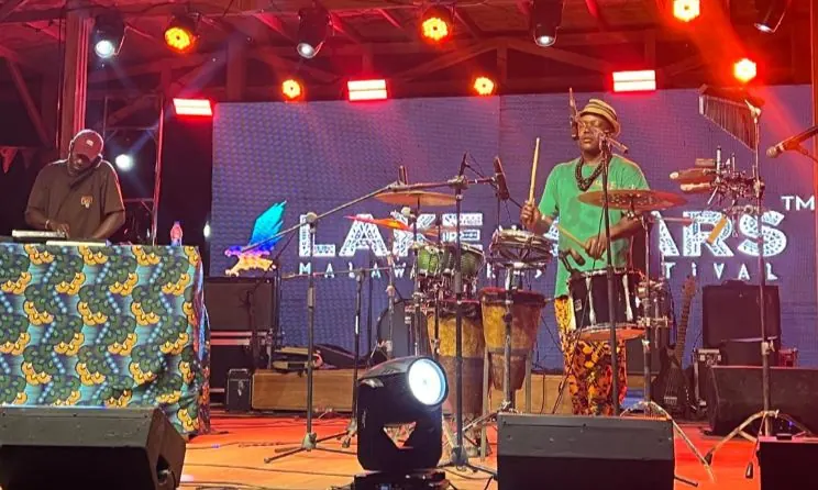 A band on the Lake of Stars stage under coloured lights
