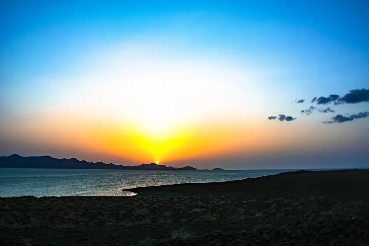 Sunset over the lake with the sun low on the horizon