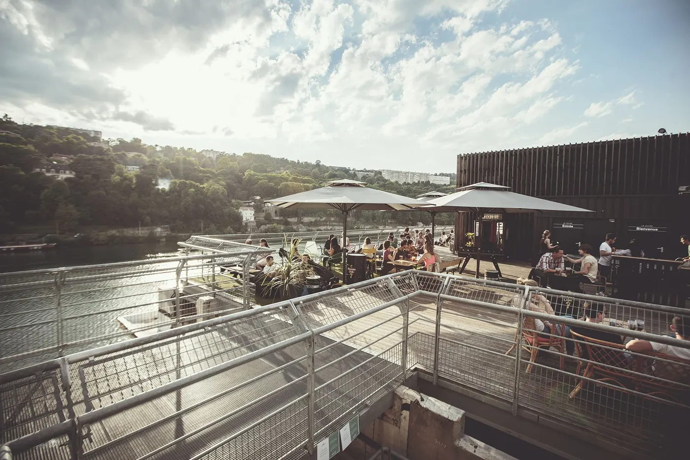 The Le Sucre rooftop terrace with parasols under a cloudy sky
