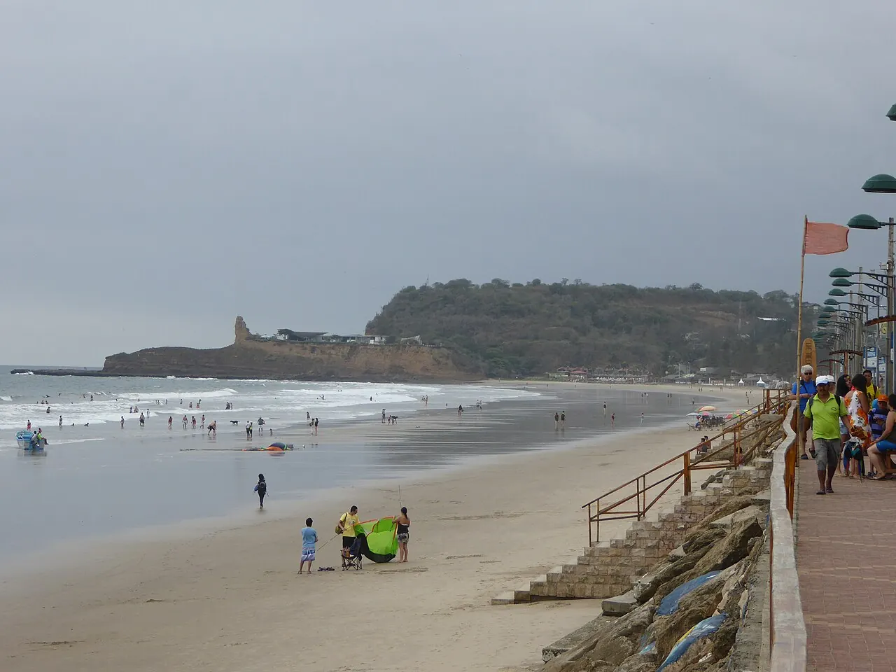 A long beach with a headland and a promenade