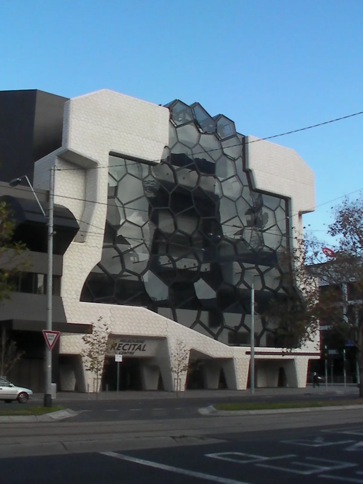 The angular grey and glass building corner from the street