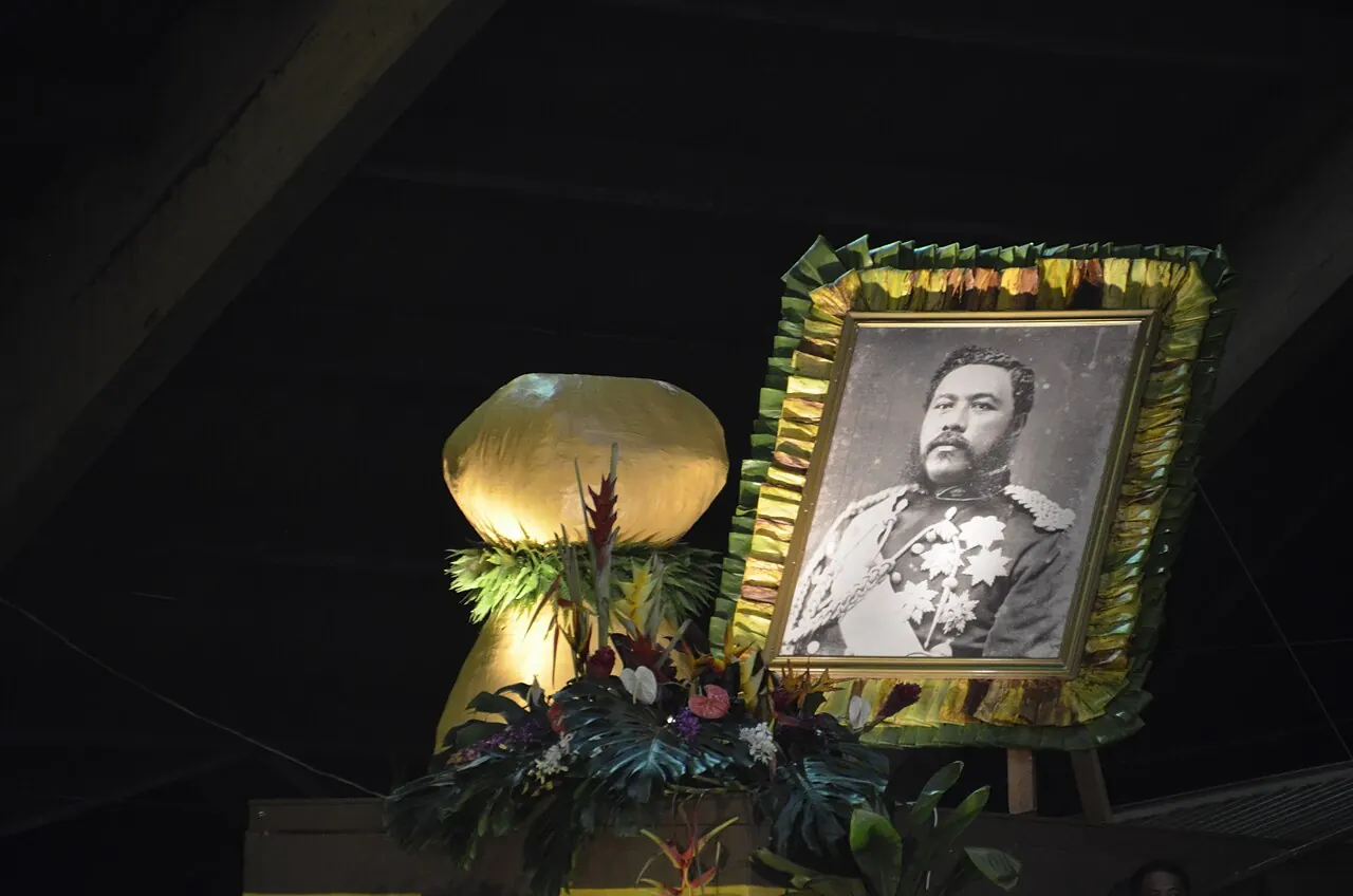 A framed portrait lit on a dark stage