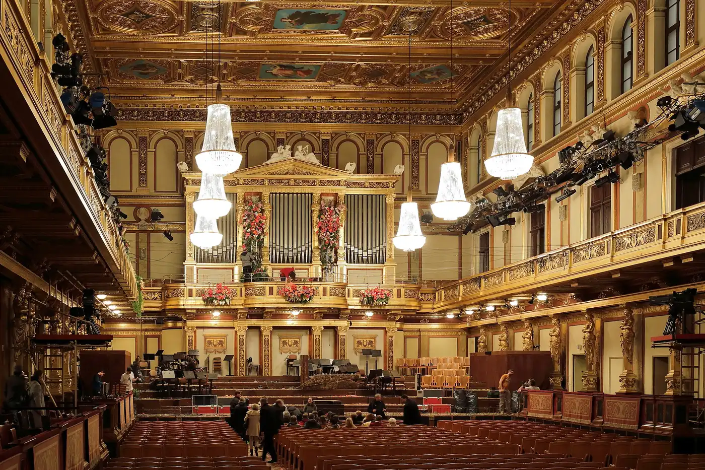 Empty Golden Hall of the Musikverein: gilded caryatids, tiered balconies, crystal chandeliers, coffered ceiling and the great organ above the stage