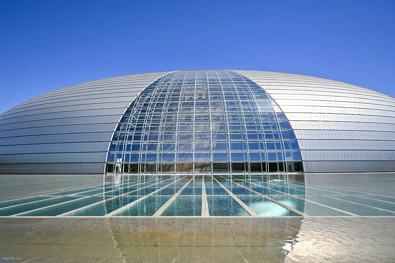 The dome and glass entrance seen from the water's edge