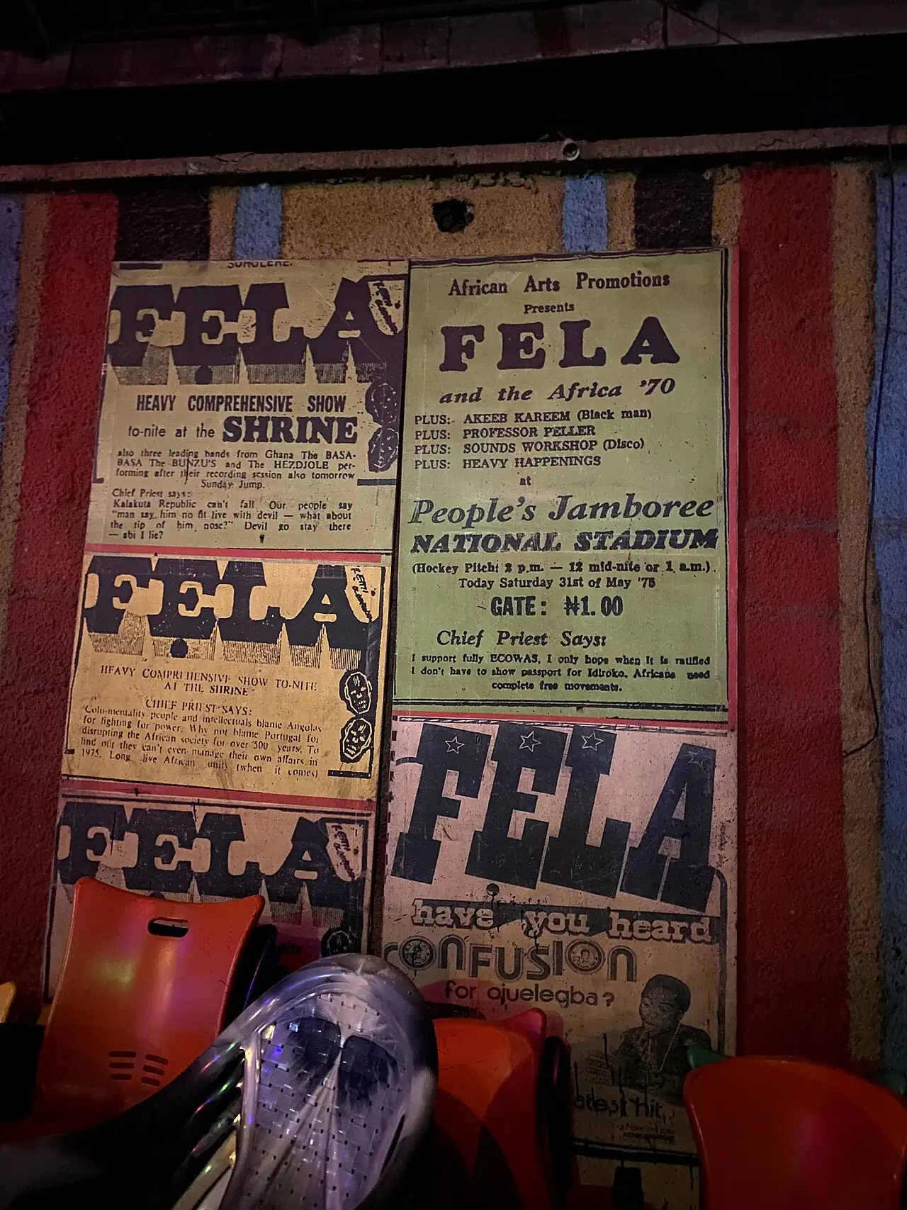 A poster wall reading Fela