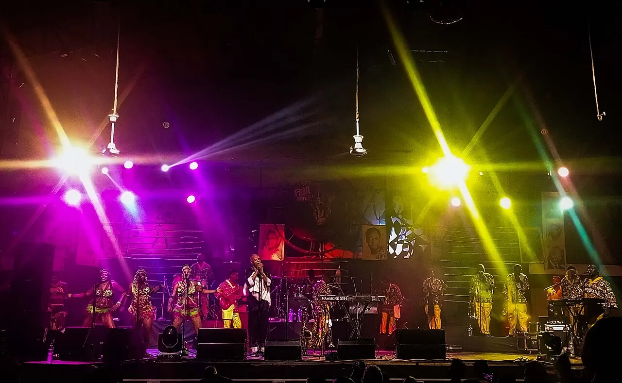 A band on stage under yellow and magenta lights