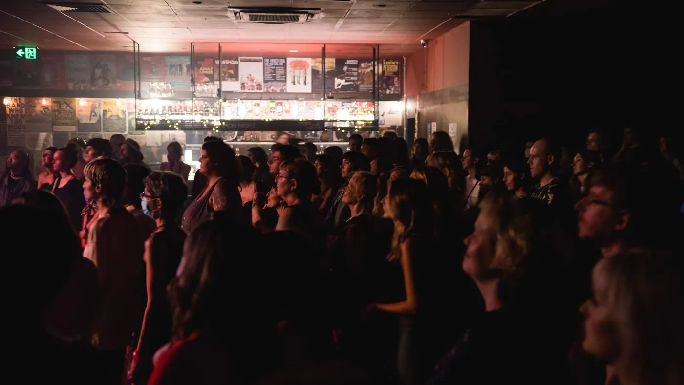 A crowd in a dark room at a gig