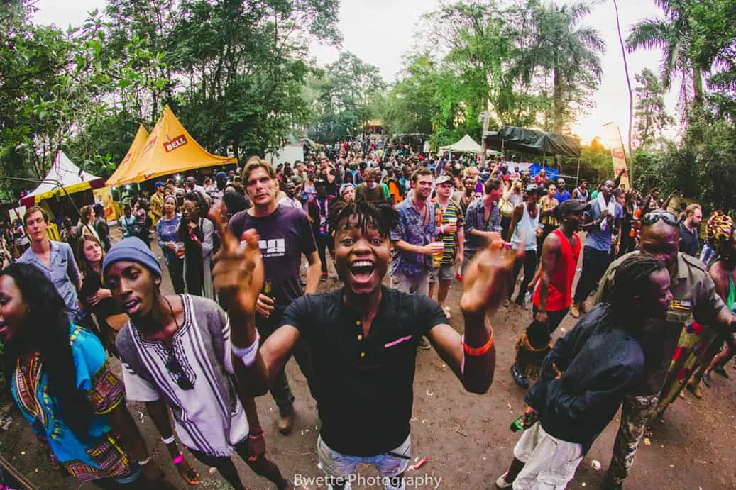 Festival-goers cheering among trees