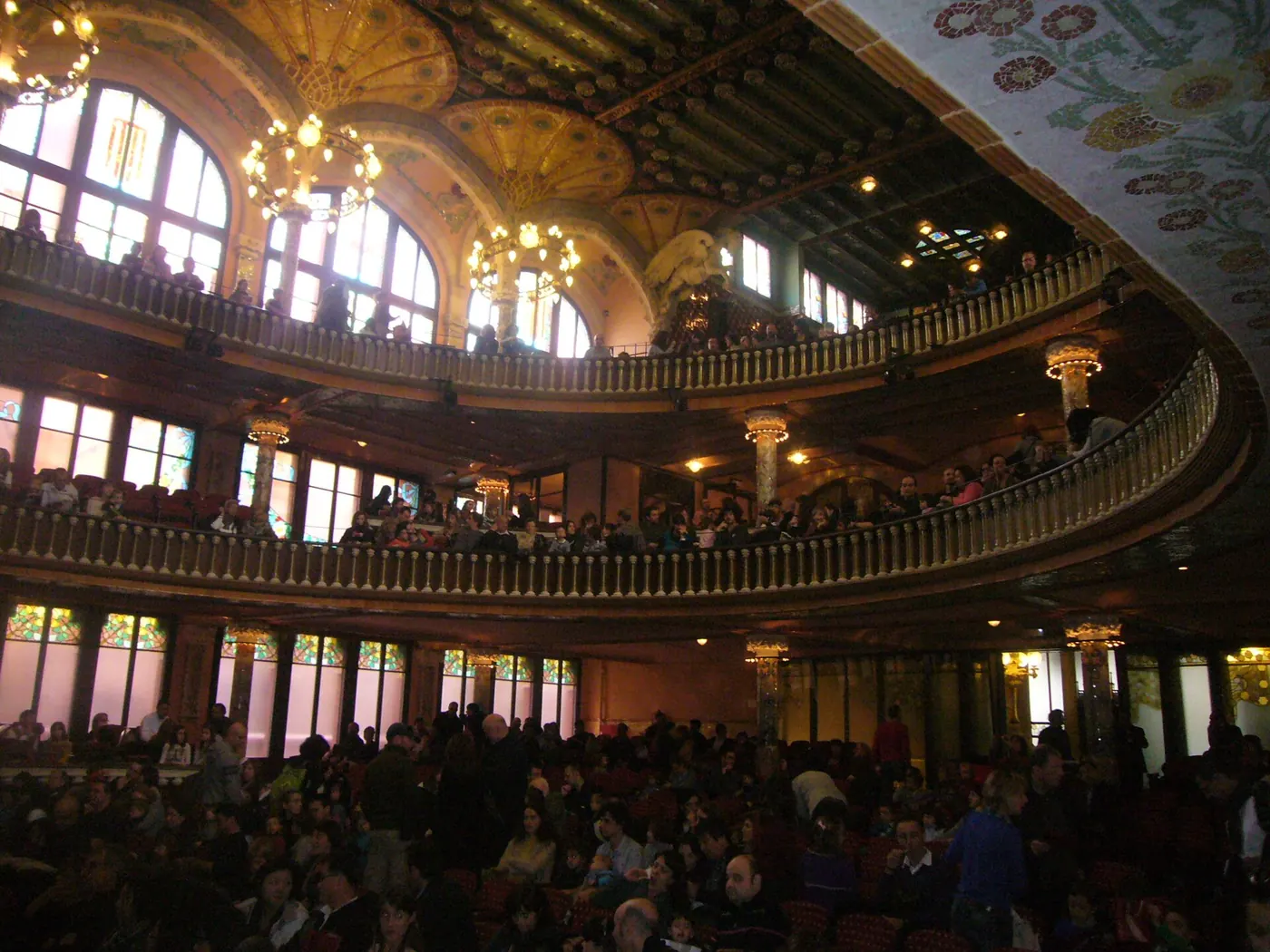 The Palau's balconies and chandeliers above a full audience