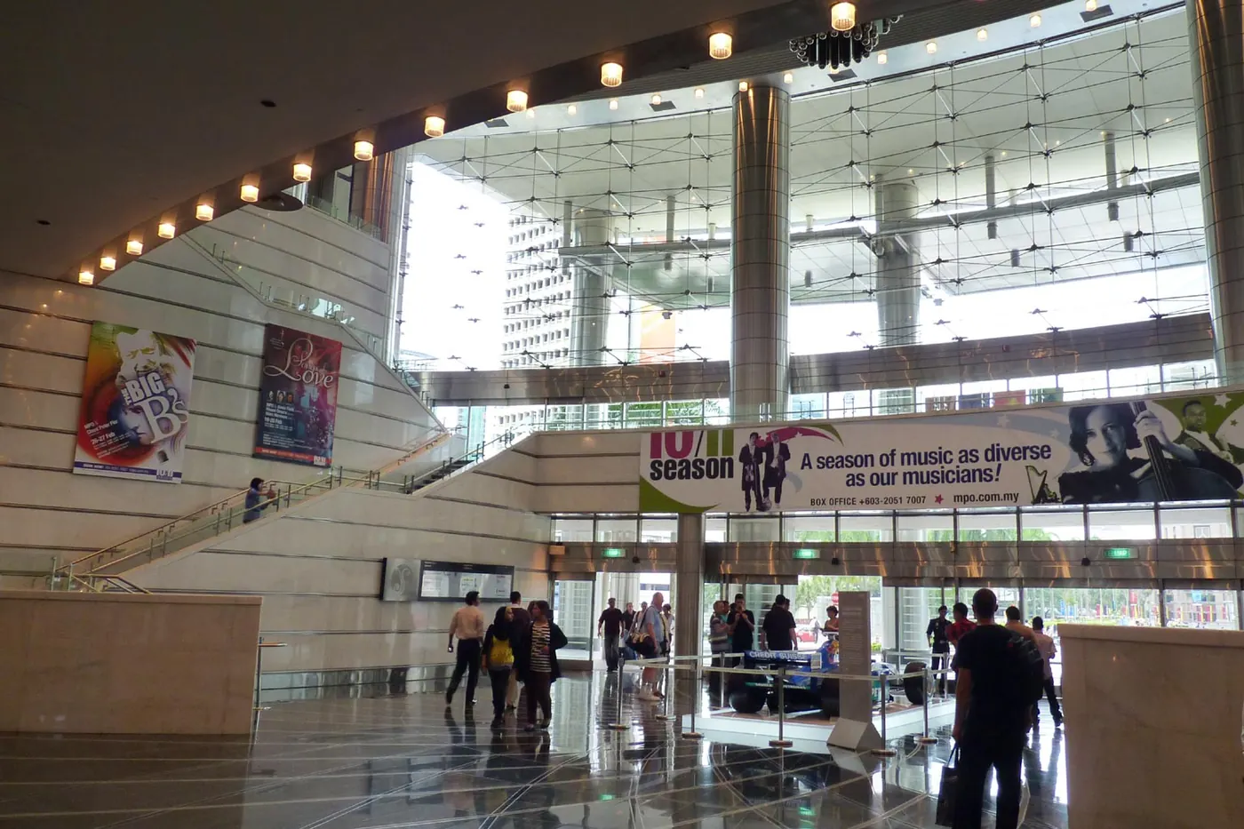 The glass-walled lobby of the hall with visitors