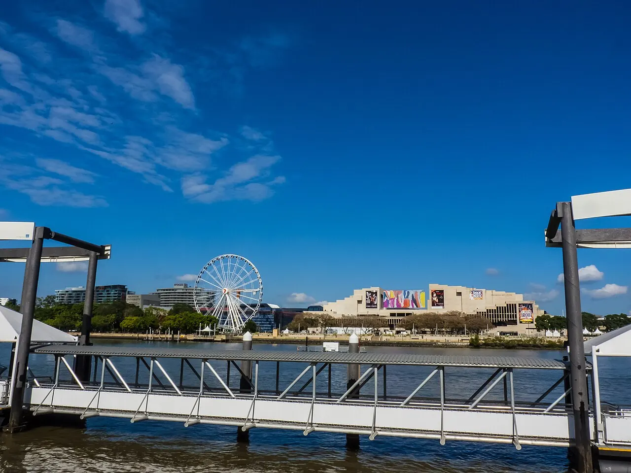 The river ferry wharf with the ferris wheel and arts precinct beyond