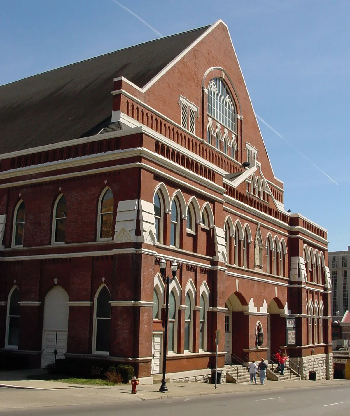 The gabled brick front of the Ryman under a blue sky