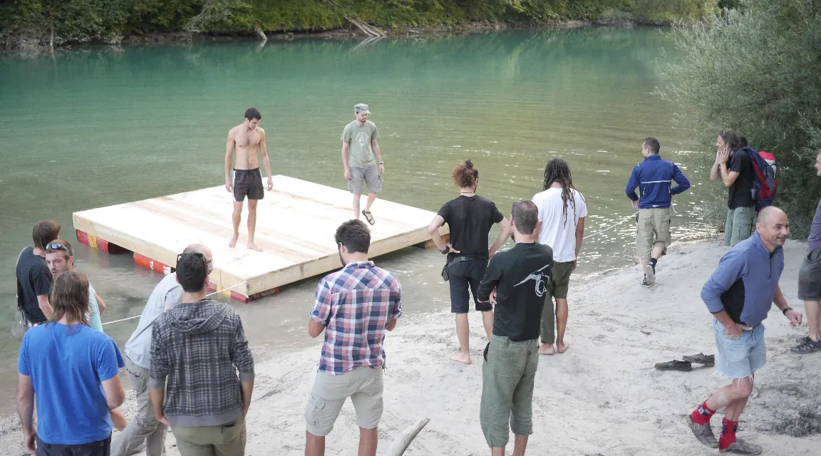 People on a floating platform on a river